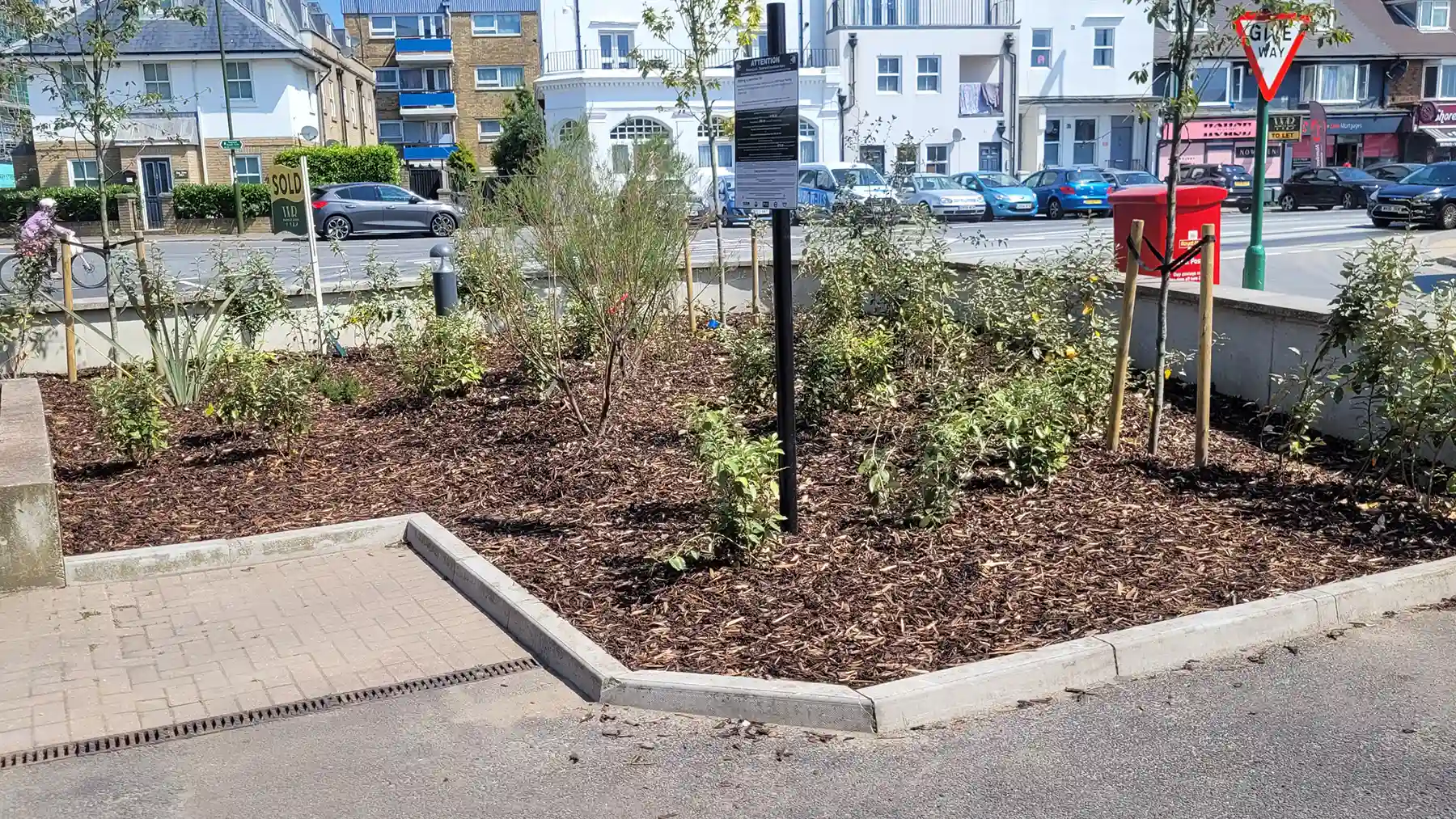 Commercial apartments front area with large range of planting and trees.