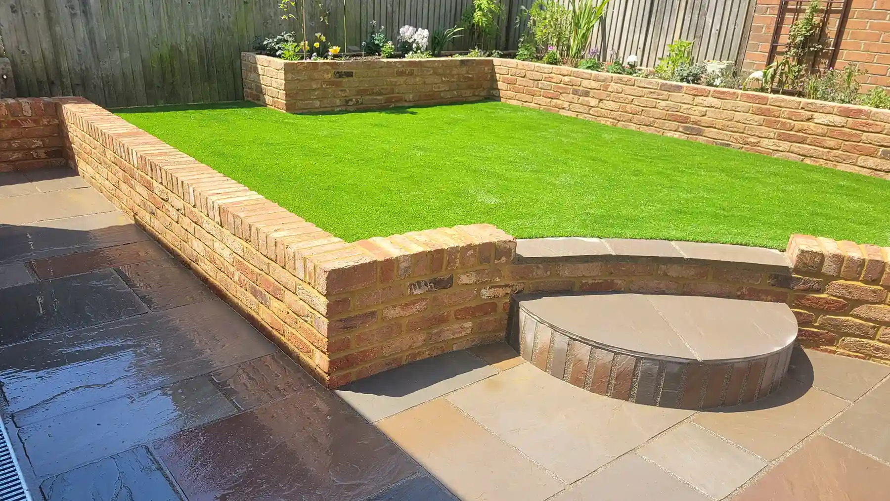 Straight and curved garden brick wall built with old farmhouse bricks.