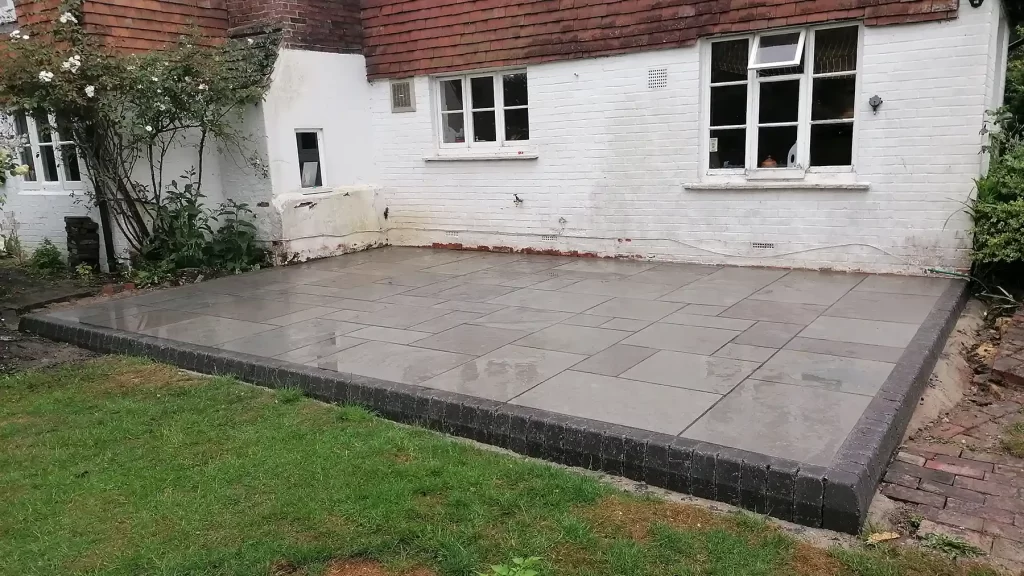 Kota blue limestone raised patio with chamfered edging.