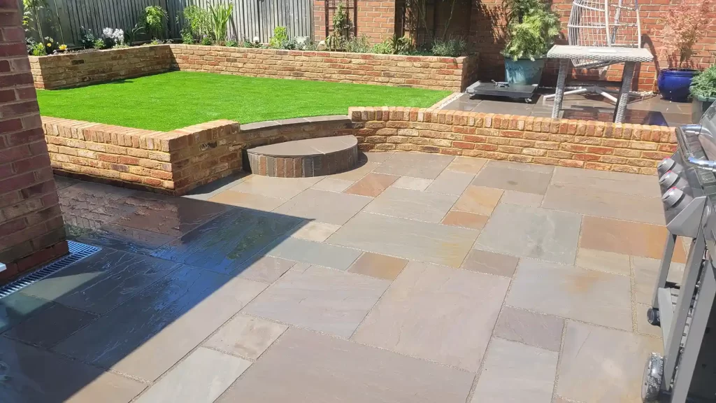 Raj blend sandstone patio area with old farmhouse brick walls.
