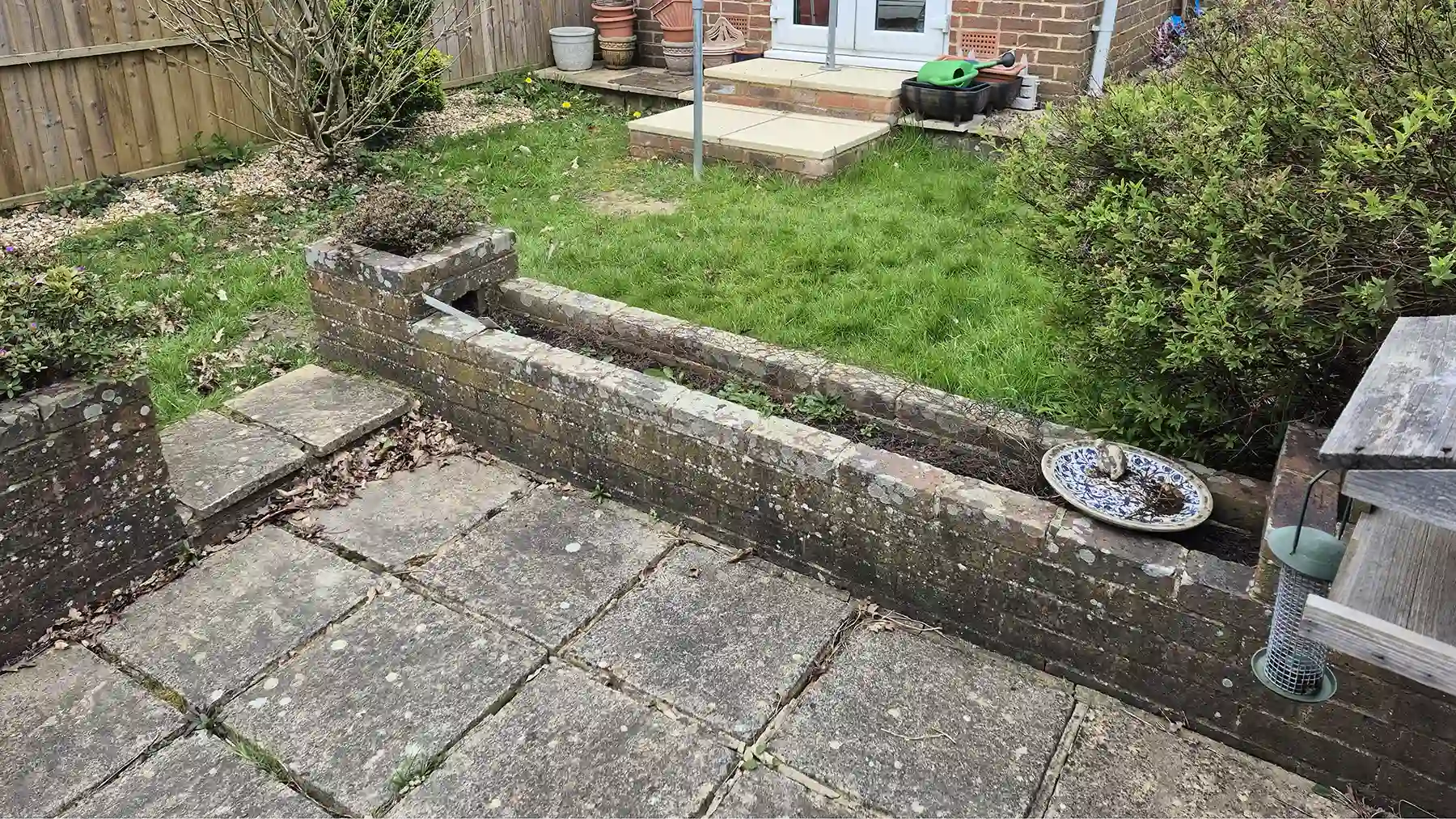 Old raised brick planter set away from the house