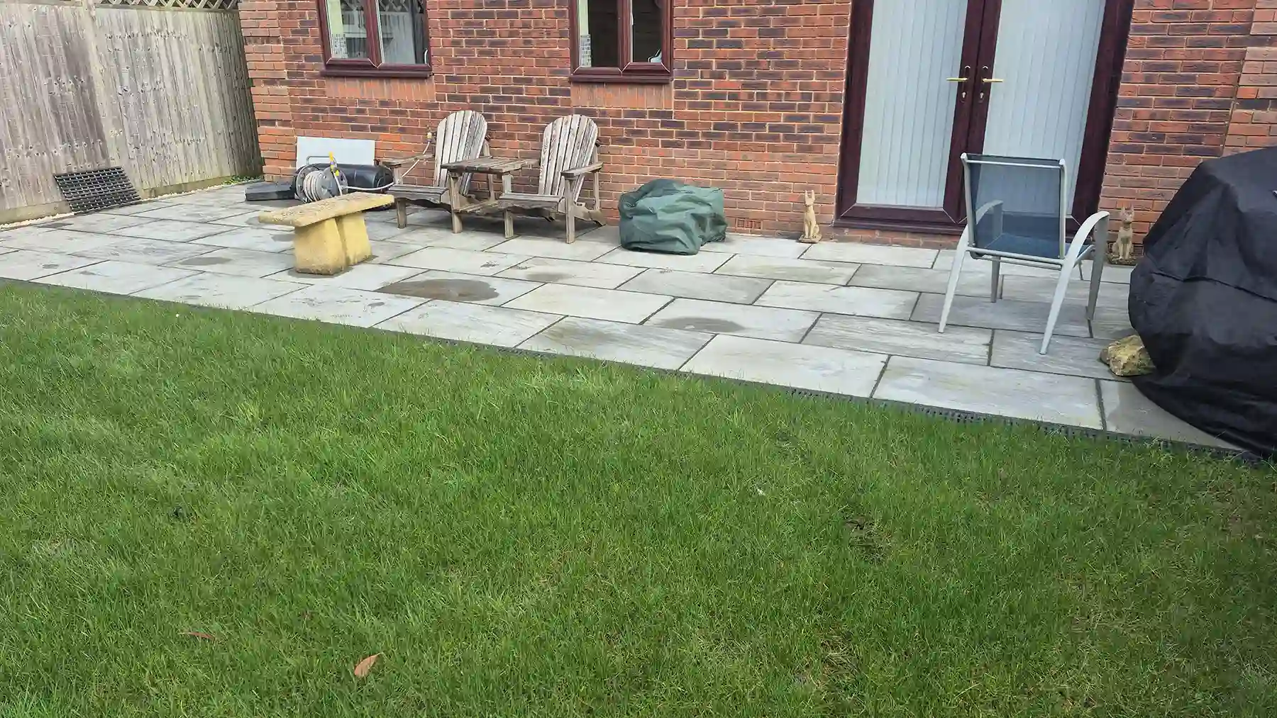 Grey sandstone paving area.